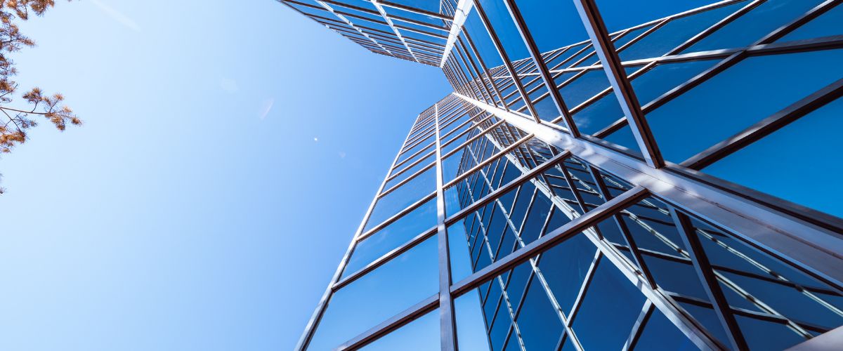 Modern glass commercial building representing real estate growth and professionalism