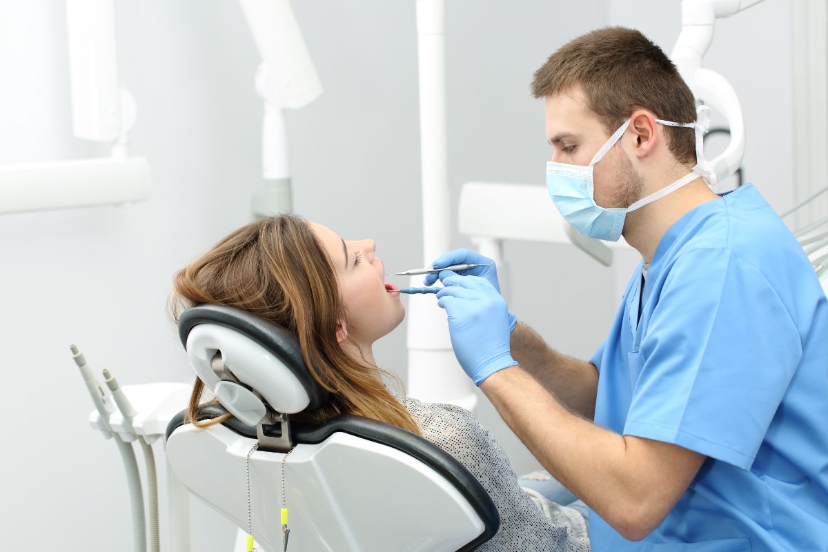Dentist treating patient in dental clinic with professional equipment